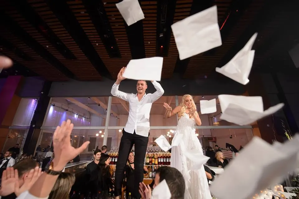 Bride and groom lifted in celebration on the dance floor